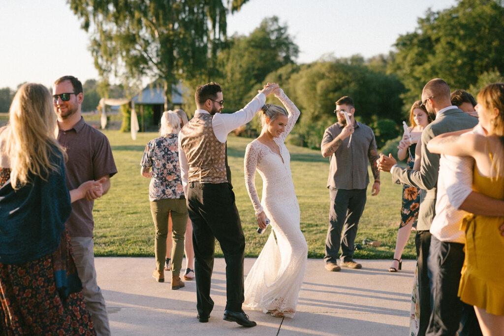 Bride and groom dance together at their Saltbox Barn wedding reception