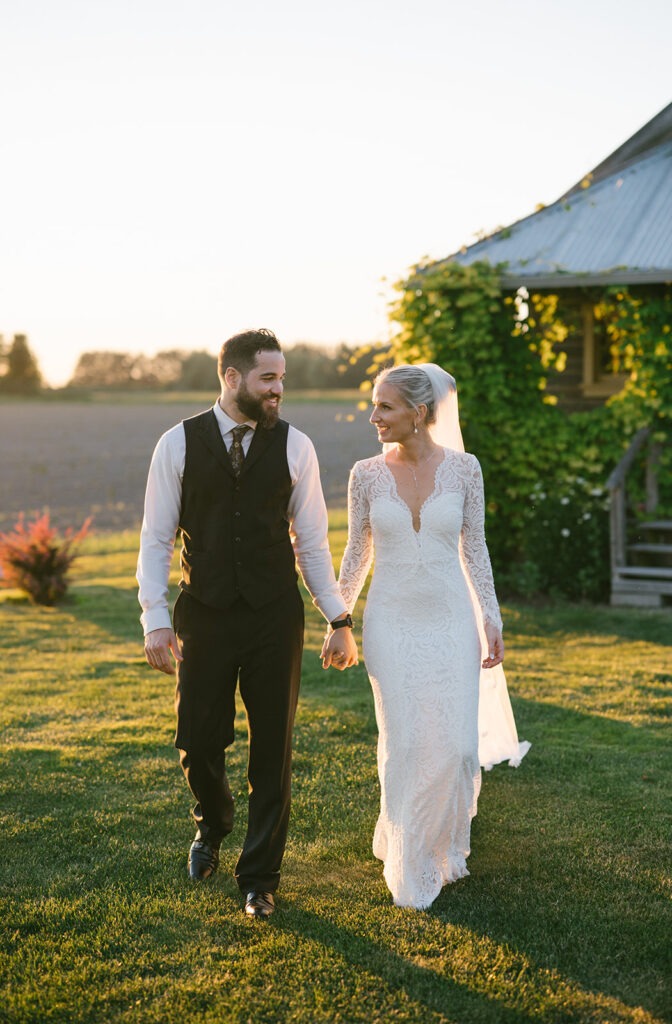 Golden hour light wraps around this laughing couple during their Saltbox Barn wedding portraits. Ask about golden hour sessions.