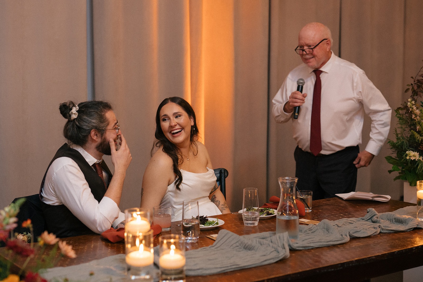 Couple reacting during reception speeches
