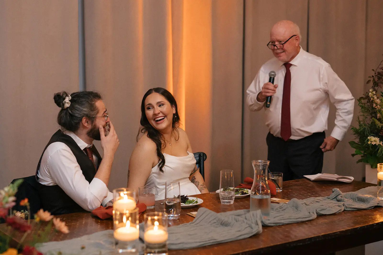 Couple reacting during reception speeches