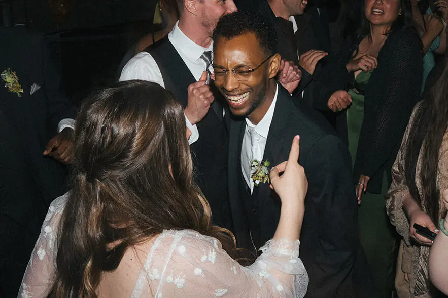 Groom dancing while surrounded by cheering guests on the dance floor at Lairmont Manor