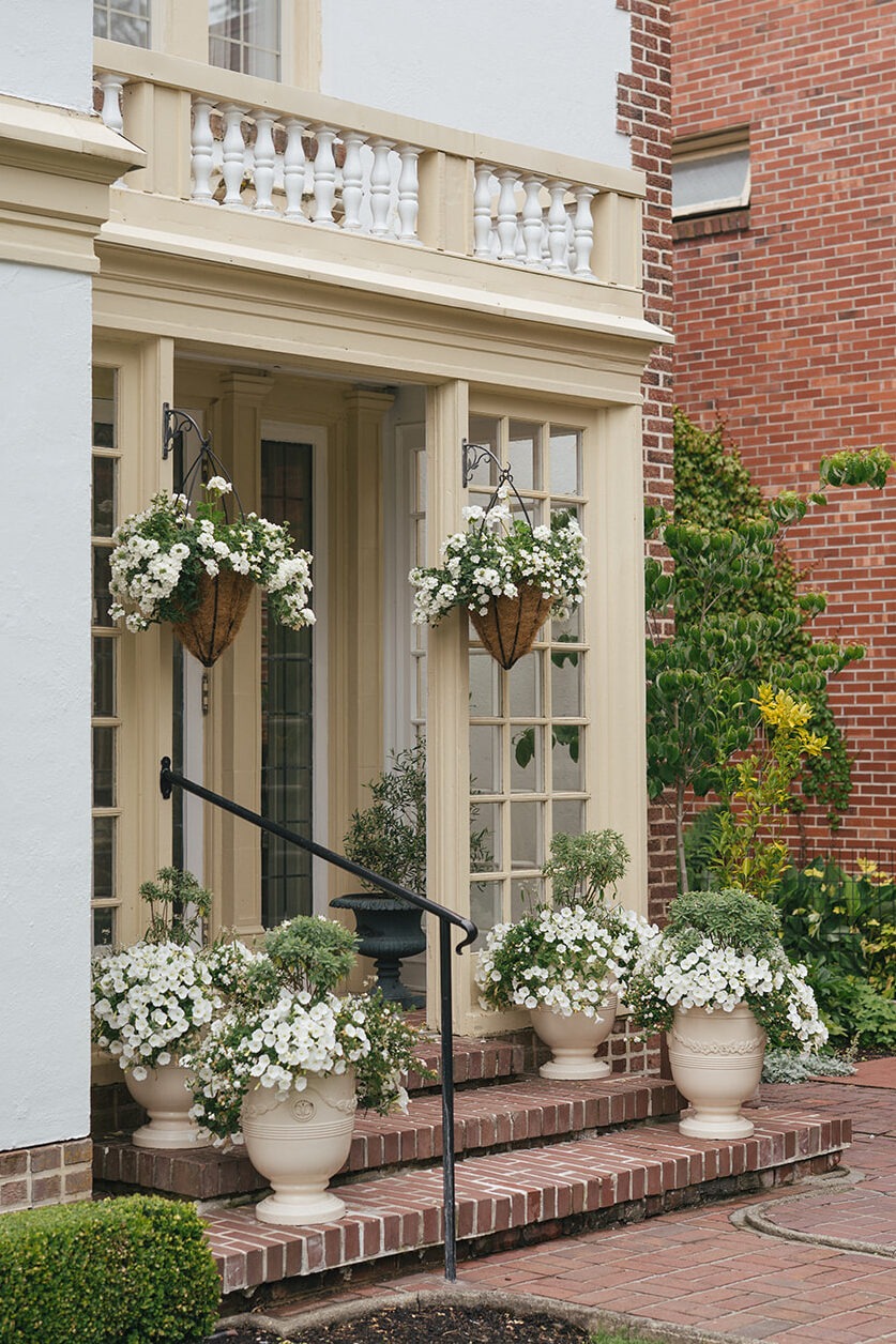 Back entrance of Lairmont Manor decorated with white florals for a wedding in Bellingham
