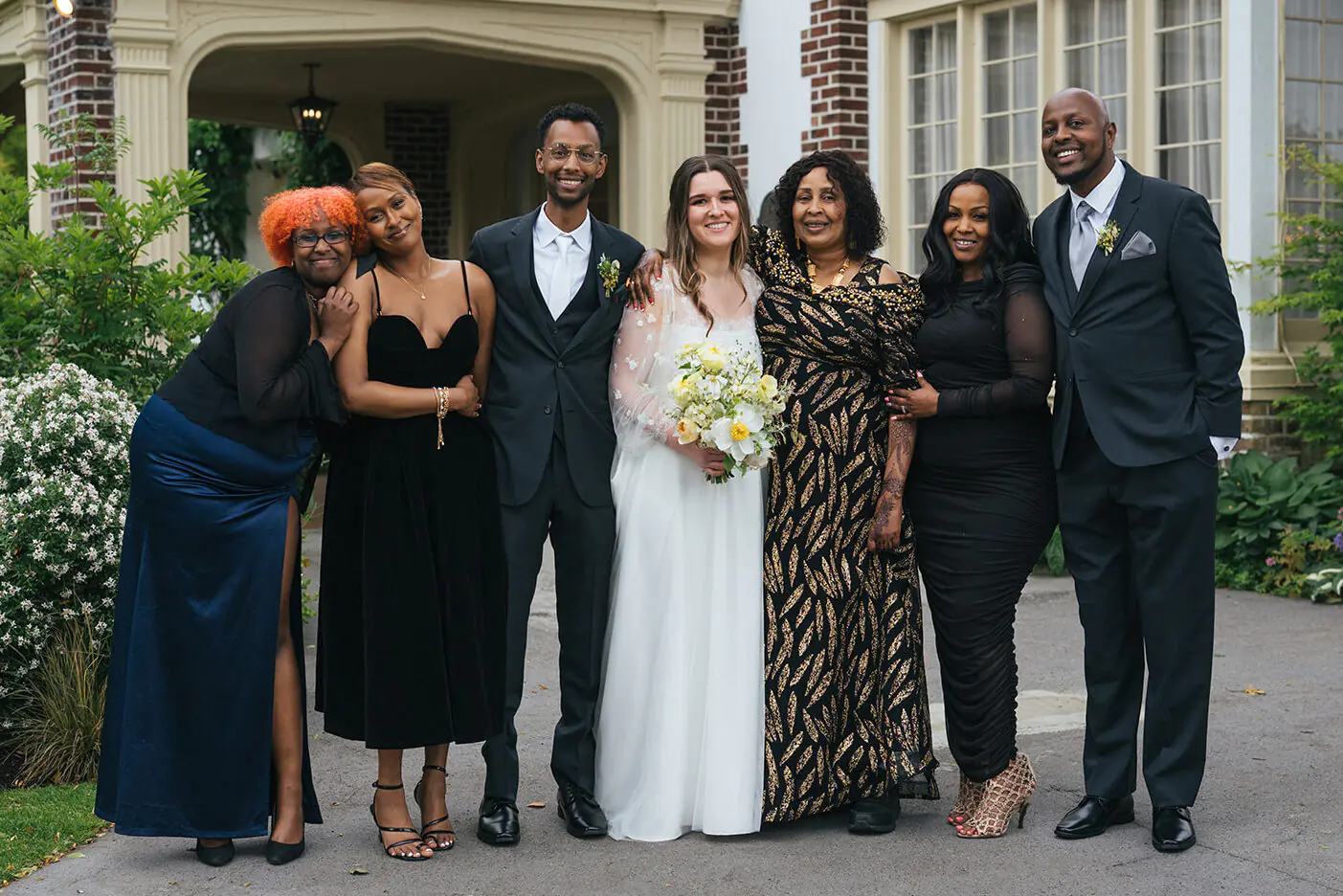 Wedding party portrait in front of Lairmont Manor with the bride and groom surrounded by family