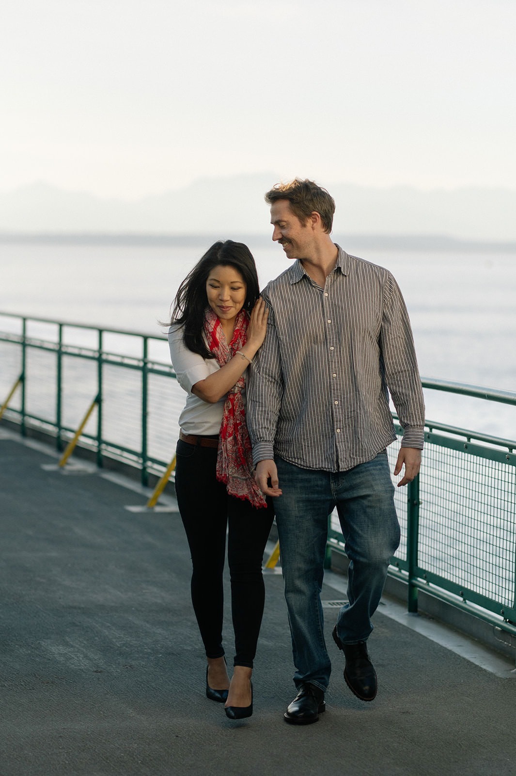Couple walking together on the ferry deck during a Seattle engagement session