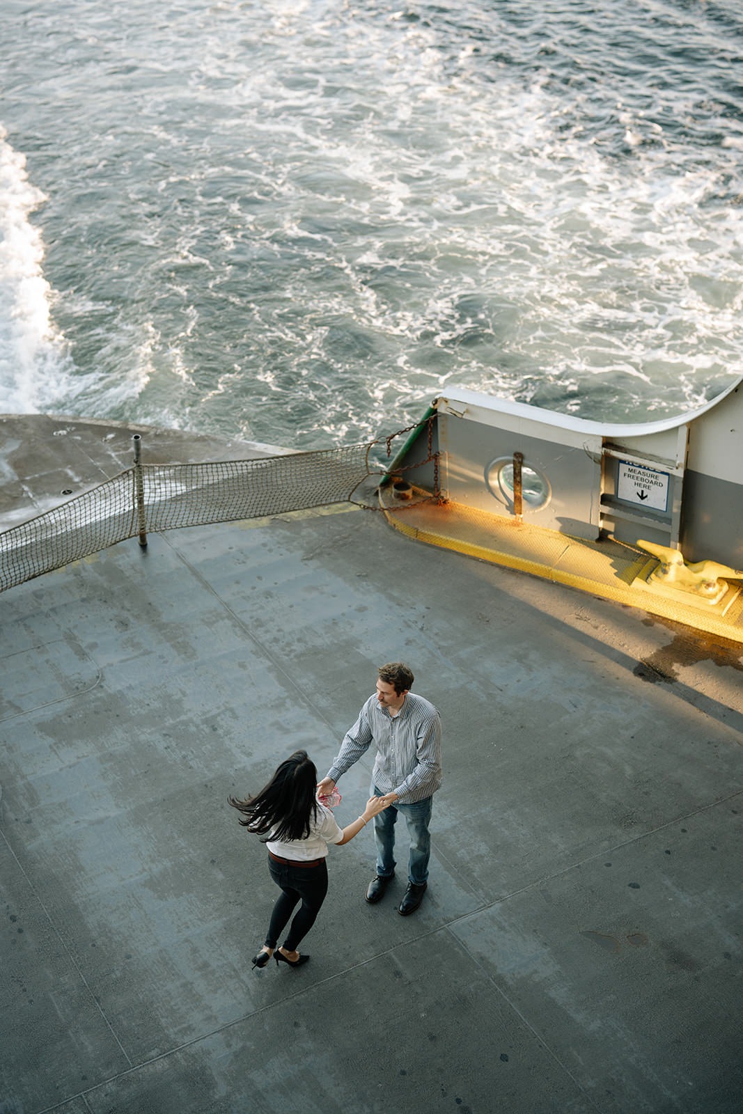 Overhead photos of a couple dancing together on the back deck of a Washington State Ferry