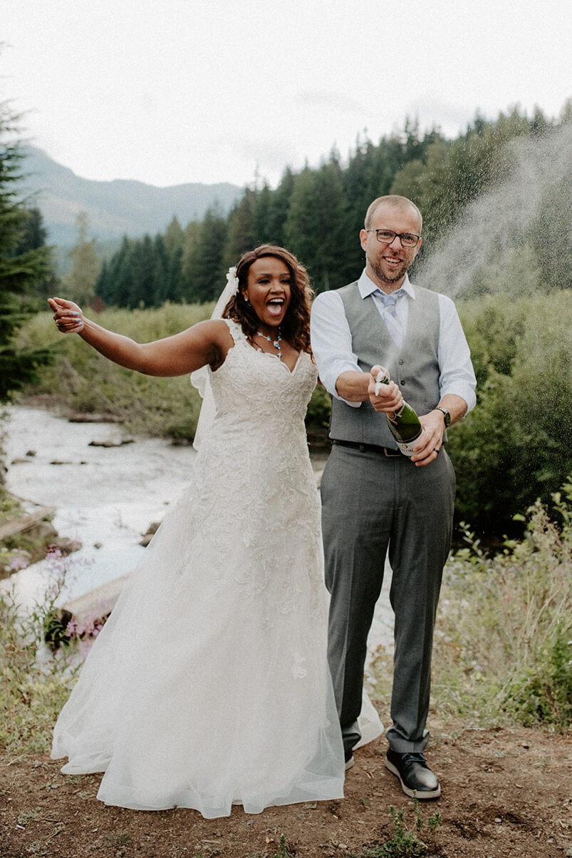 Newlyweds celebrating with champagne after their intimate Pacific Northwest elopement
