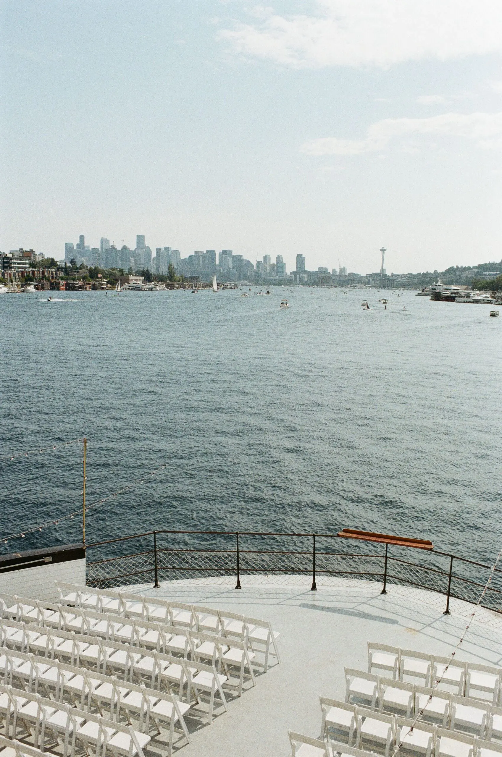 Wedding ceremony chairs set up on the bow of MV Skansonia with Lake Union and the Seattle skyline behind the altar