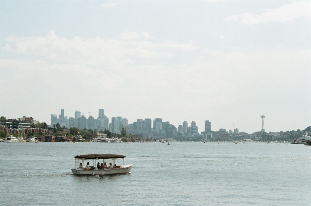 Small boat on Lake Union with the Seattle skyline and Space Needle in the background