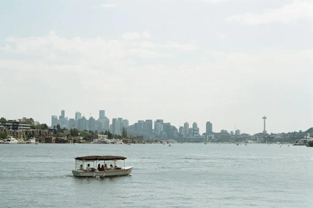 Small boat on Lake Union with the Seattle skyline and Space Needle in the background