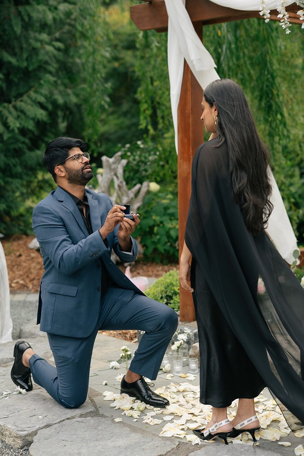 Piyush gets down on one knee to propose to Priyanka under a wisteria-draped arch at Willows Lodge