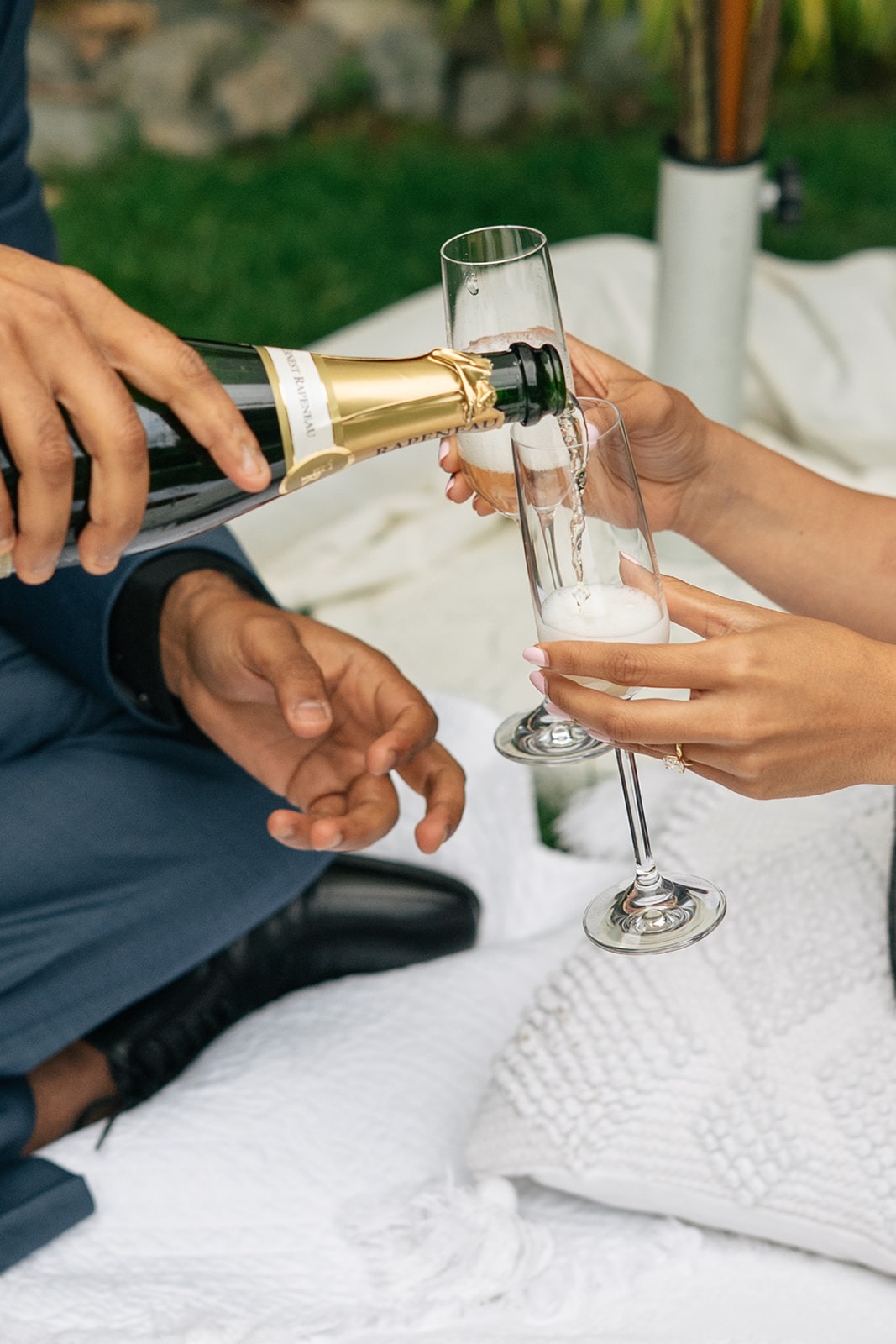 Close-up of champagne being poured into a flute at a post-proposal picnic in Woodinville, WA