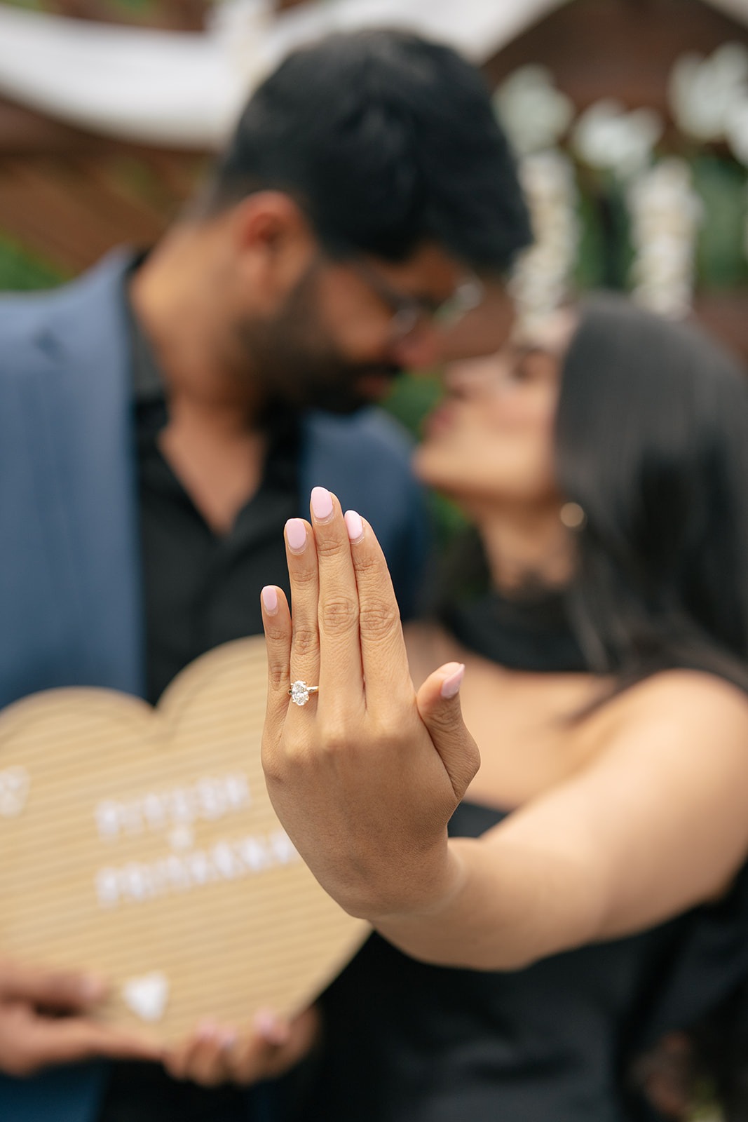Close-up of Priyanka's engagement ring with Piyush kissing her softly in the background at their Woodinville proposal