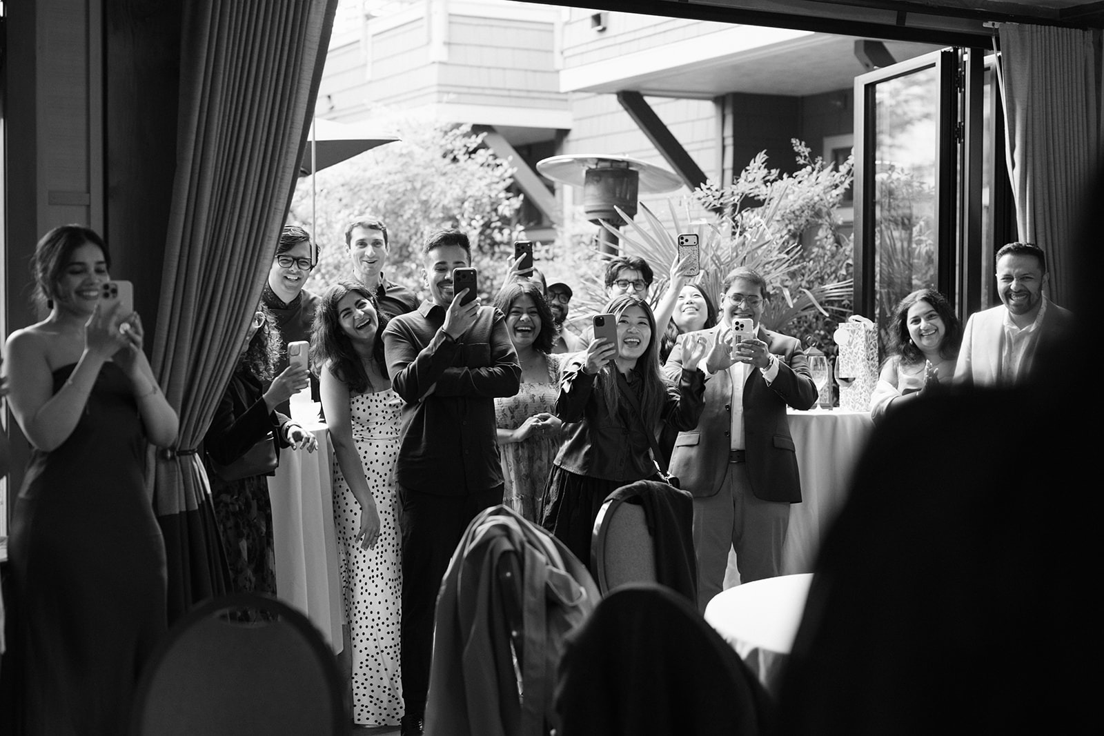 Piyush and Priyanka's friends and family capture the surprise engagement reveal on their phones at Willows Lodge in Woodinville