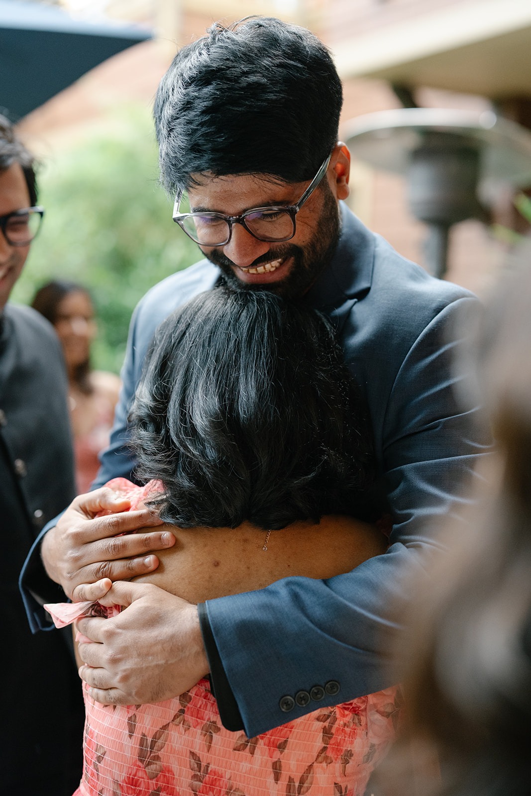 Piyush embraces a friend during the surprise engagement party at Willows Lodge