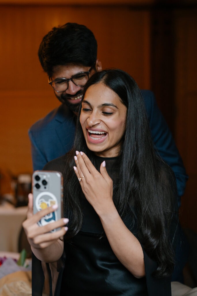 Priyanka shows off her engagement ring on a video call with loved ones while Piyush hugs her from behind
