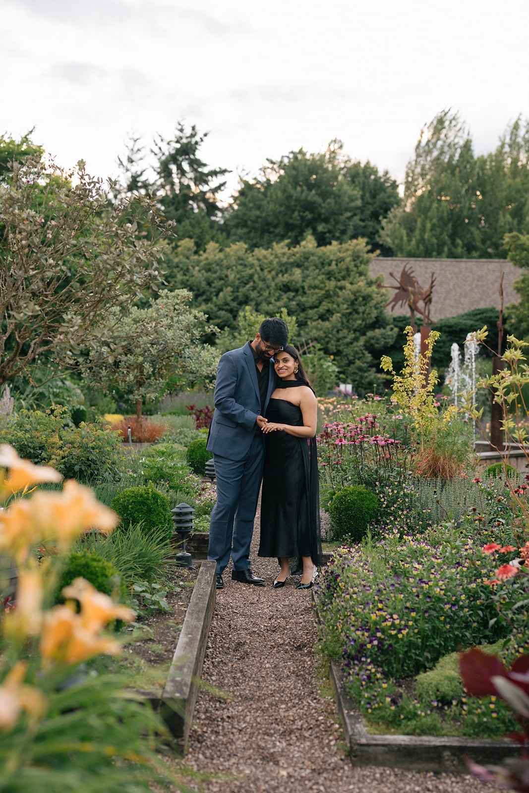 Piyush rests his forehead against Priyanka's on a garden path at Willows Lodge during their engagement session