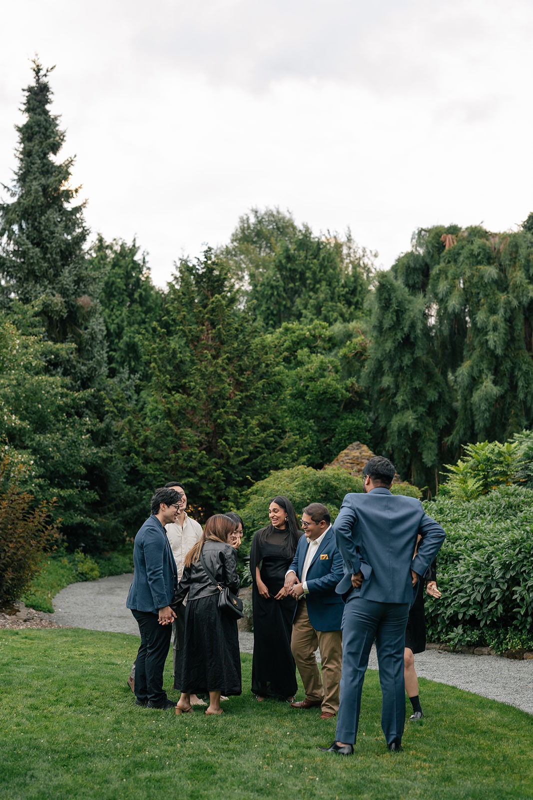 Friends and family gather around Piyush and Priyanka in the gardens at Willows Lodge after the surprise proposal