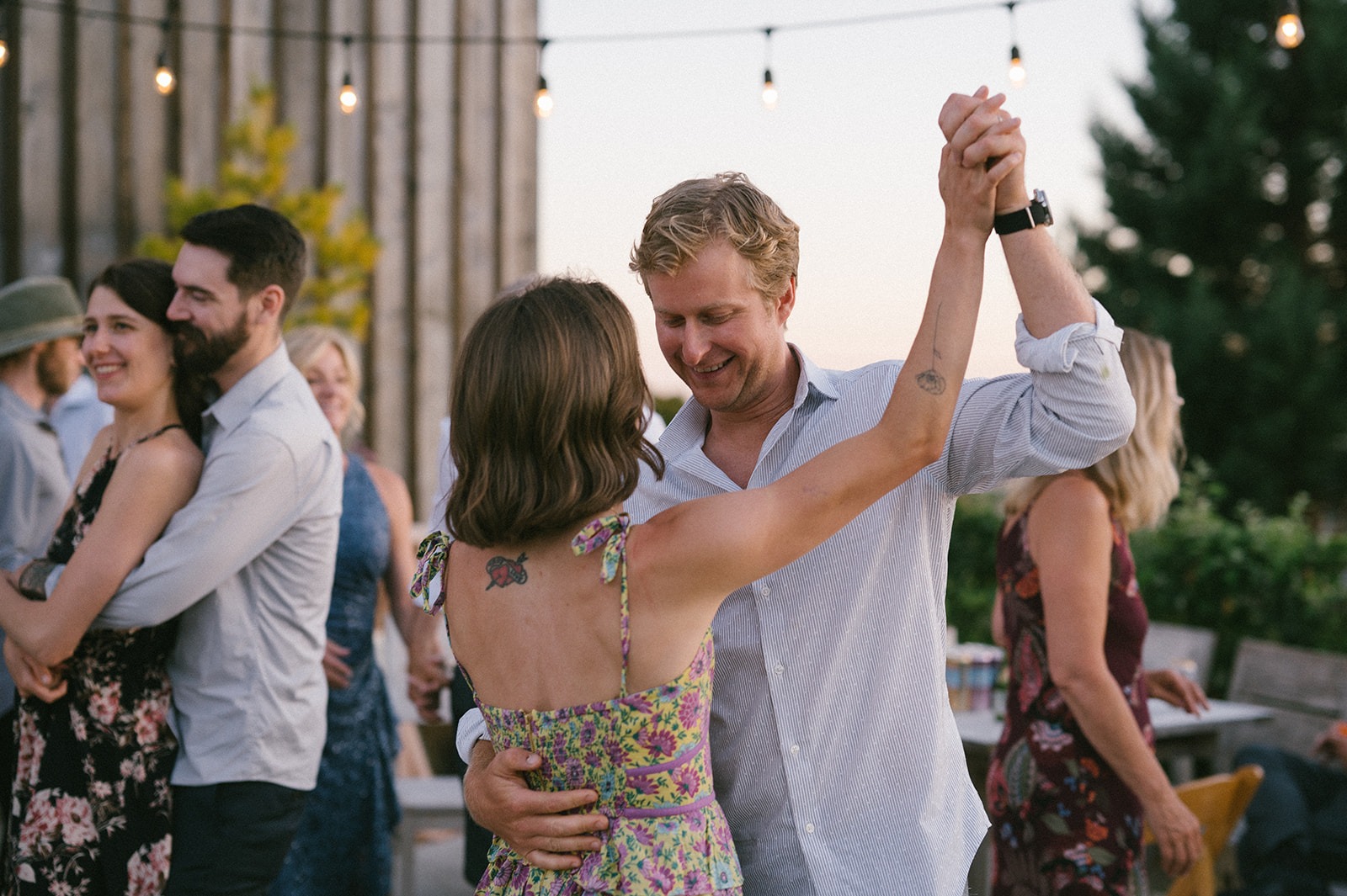 Two couples spin and dance together at this Saltbox Barn wedding reception